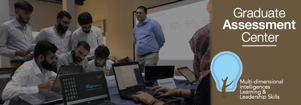 Graduates participating in MILLS experiential Graduate Assessment Center led by certified assessors on client premises.